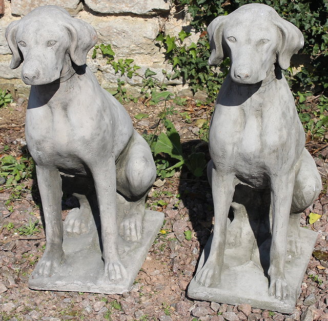 Appraisal: A PAIR OF CAST STONE RECONSTITUTED HOUNDS sat on their