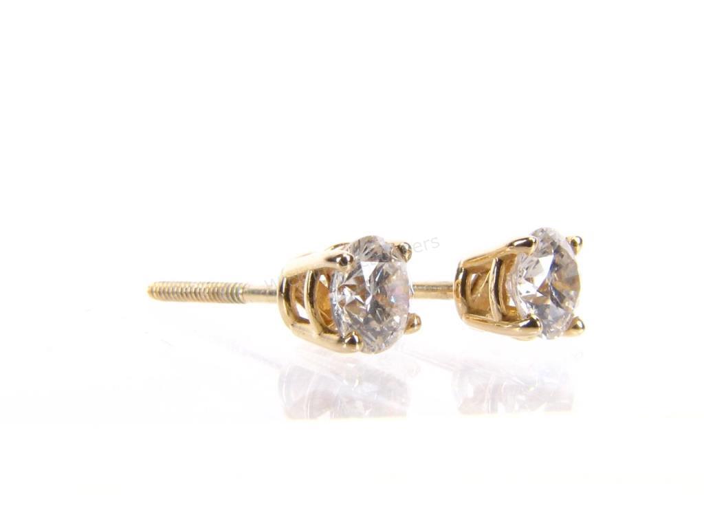 Appraisal: A pair of K yellow gold four-prong earrings trademarked and