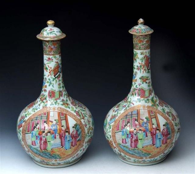 Appraisal: A PAIR OF CANTON CELADON GROUND BOTTLE VASES and covers