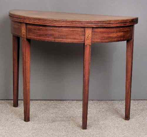 Appraisal: A George III mahogany semi circular tea table inlaid with