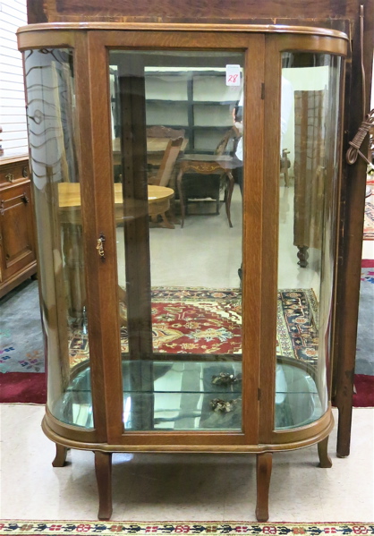 Appraisal: AN OAK AND CURVED GLASS CHINA CABINET American c centering