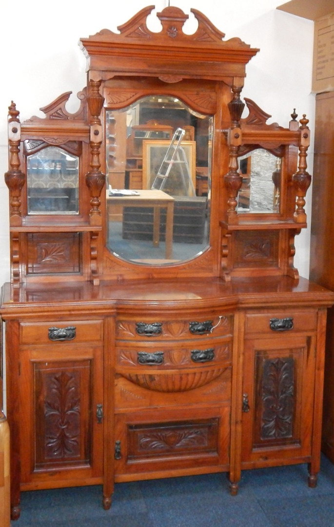 Appraisal: A Victorian walnut sideboard the broken arch pediment above a