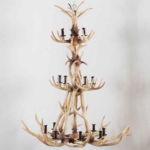 Appraisal: LARGE FAUX ANTLER AND EBONIZED METAL SIXTEEN-LIGHT CHANDELIER ft in