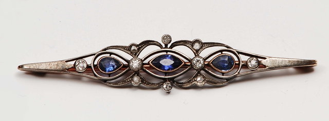 Appraisal: An Edwardian bar broochof stylised form with sapphire and diamond