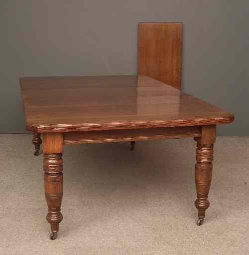 Appraisal: A late Victorian oak extending dining table with two extra