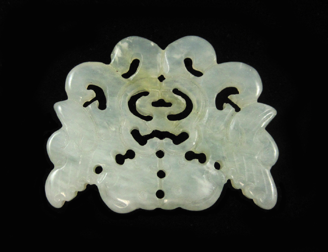 Appraisal: CHINESE LIGHT GREEN JADE PENDANT The jade carving measures -