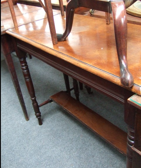 Appraisal: A mahogany table with turned legs and platform stretcher th