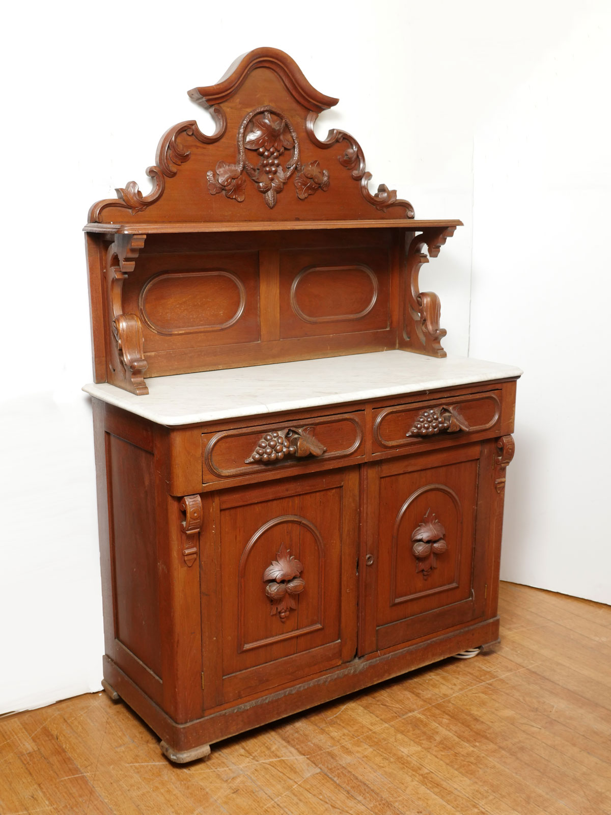 Appraisal: WALNUT MARBLE TOP BUFFET Carved Walnut buffet having a scrolling