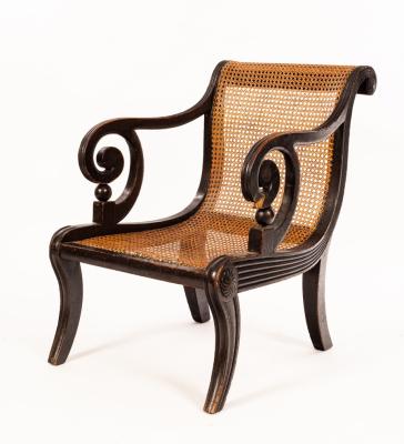 Appraisal: A Regency ebonised library chair with cane seat and scroll