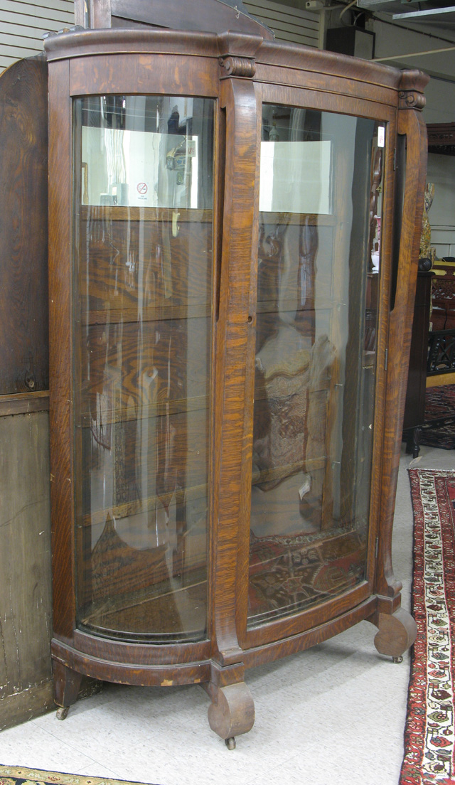 Appraisal: AN OAK AND CURVED GLASS CHINA DISPLAY CABINET Empire Revival