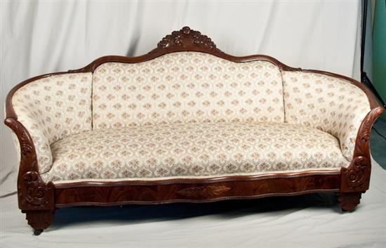 Appraisal: Victorian Mahogany Sofa Beautifully carved details floral print upholstery