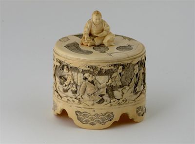 Appraisal: A Japanese ivory oval box and cover with a figural