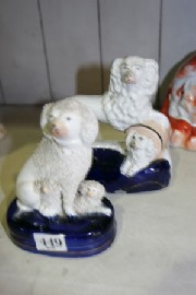 Appraisal: A Staffordshire model of a poodle with two puppies circa