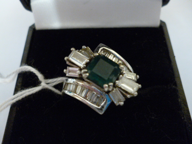 Appraisal: AN EMERALD AND DIAMOND COCKTAIL RING the square cut emerald