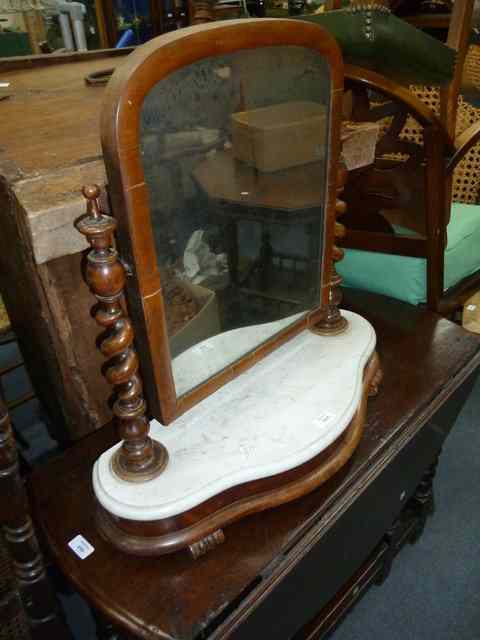 Appraisal: A WALNUT FRAMED DRESSING TABLE MIRROR standing on barley twist