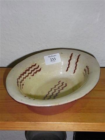 Appraisal: A BRANNAM POTTERY MEAT DISH of cream ground with wavy