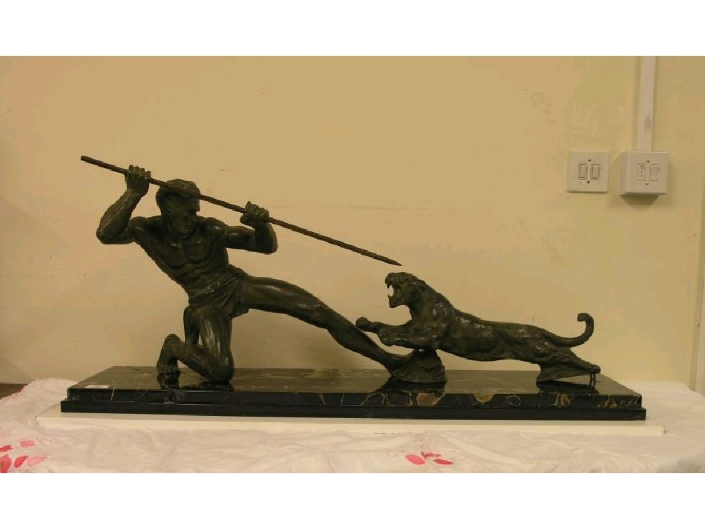 Appraisal: A bronze model of a man slaying a tiger with