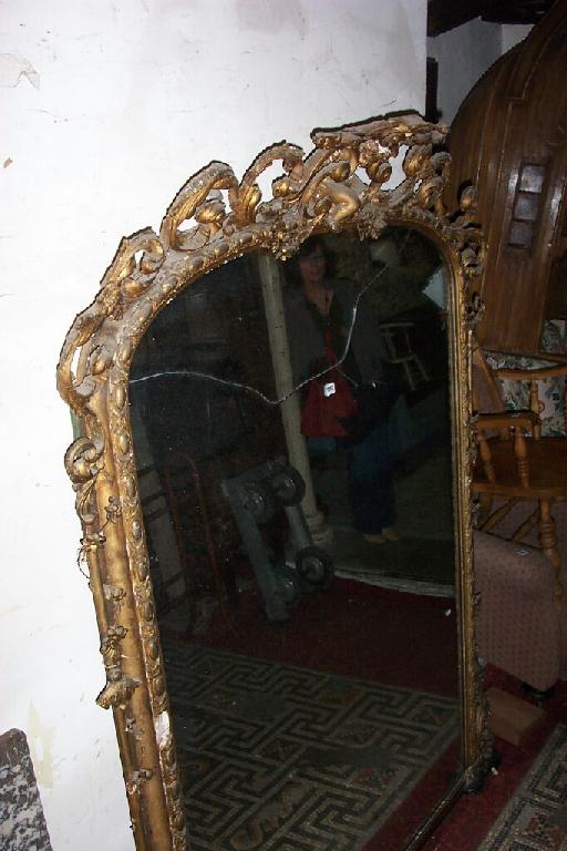 Appraisal: A large Victorian overmantle wall mirror the arched and gilded