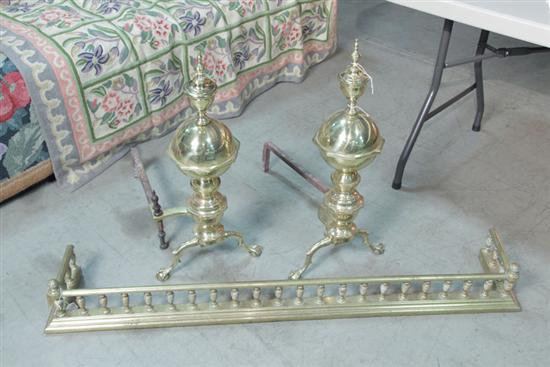 Appraisal: PAIR OF ANDIRONS AND FIREPLACE FENDER Brass and iron Andirons