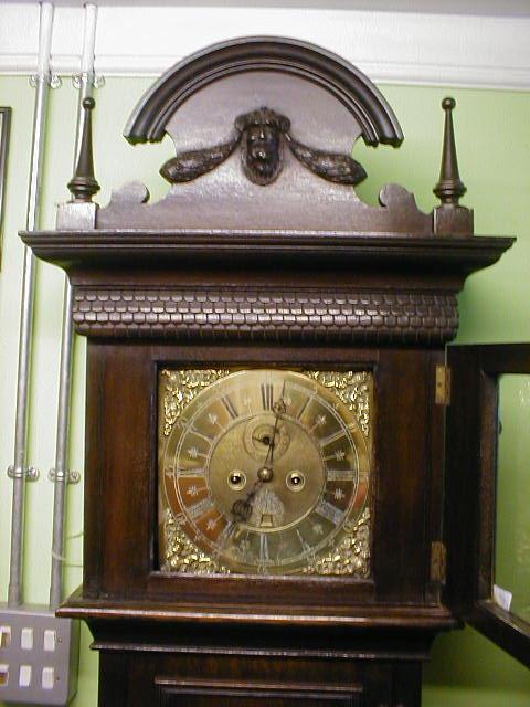 Appraisal: A carved oak longcase clock with brass dial inscribed W