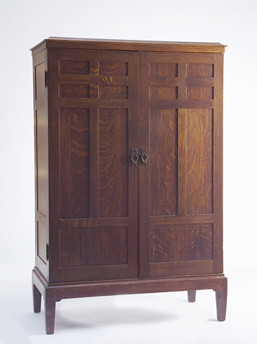 Appraisal: GUSTAV STICKLEY Two-door armoire with paneled doors and sides hammered