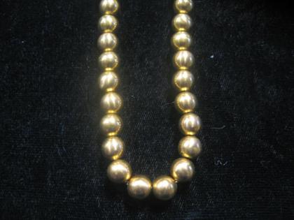 Appraisal: Gold bead necklace Strung on karat yellow gold chain L