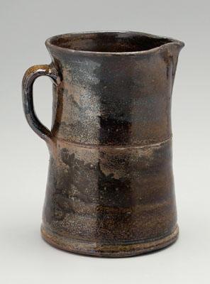 Appraisal: Stoneware pitcher tapering body with applied strap handle mottled brown