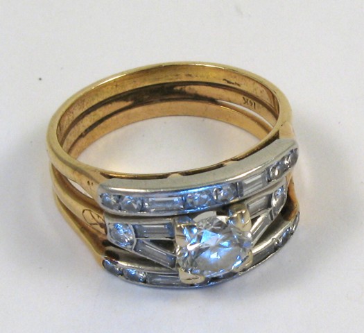 Appraisal: DIAMOND AND FOURTEEN KARAT GOLD RING centering a round brilliant-cut