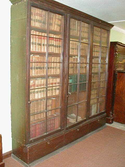 Appraisal: A thC glazed mahogany three door bookcase with cupboard base