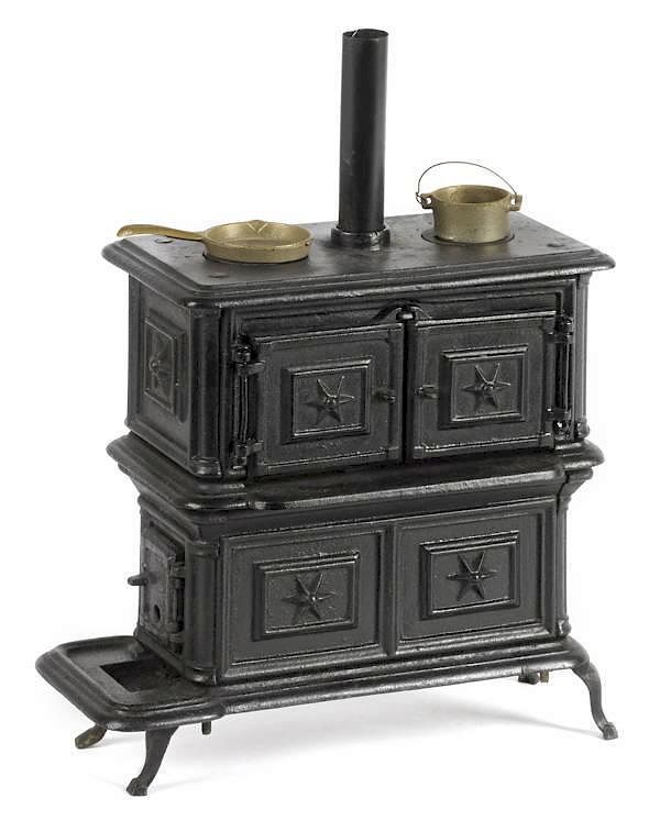 Appraisal: Cast iron toy stove '' h '' w together wit