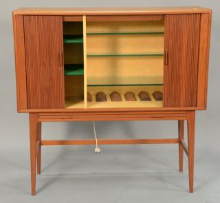 Appraisal: Modern teak bar cabinet with tambor sliding doors opening to