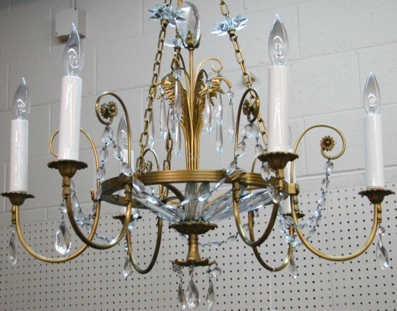 Appraisal: A pair of gilt metal chandeliers with crystal prisms and