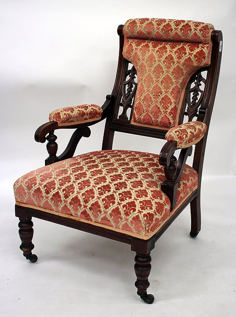 Appraisal: A LATE VICTORIAN MAHOGANY FRAMED LOW ARMCHAIR upholstered in Fleur