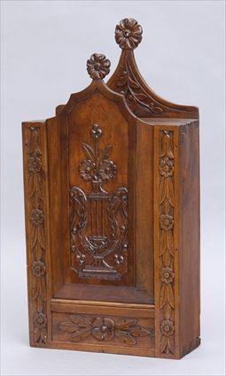 Appraisal: BRITTANY PROVINCIAL CARVED WALNUT HANGING BOX The sliding front relief-carved