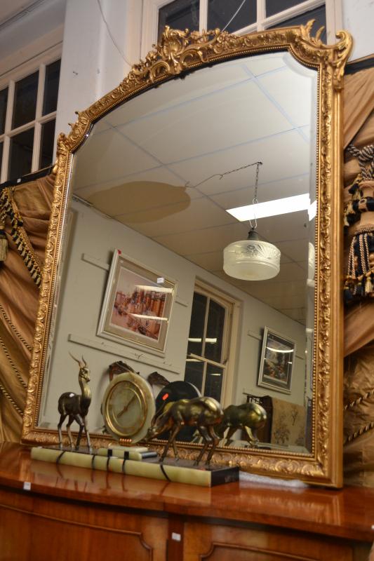 Appraisal: A LARGE CLASSICAL STYLE GILT FRAMED MIRROR FEATURING A BEVELLED