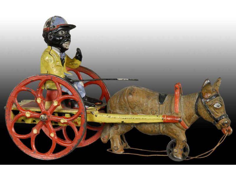 Appraisal: Cast Iron Jockey on Mule Cart Description Manufactured by J