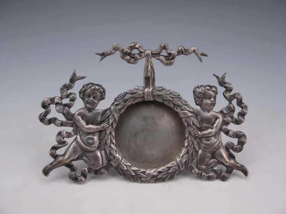 Appraisal: SHIEBLER STERLING PUTTI WATCH STAND Featuring putti wreath and ribbon