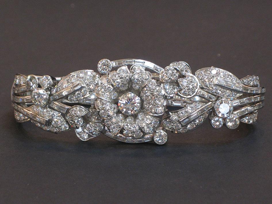 Appraisal: A DIAMOND-SET BRACELET modelled as an Art Deco style flowerhead