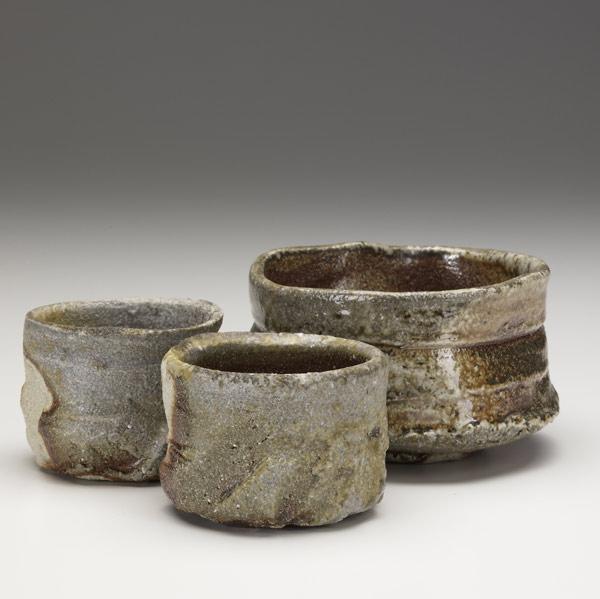 Appraisal: PETER CALLAS Wood-fired stoneware teabowl and two teacups Bowl x