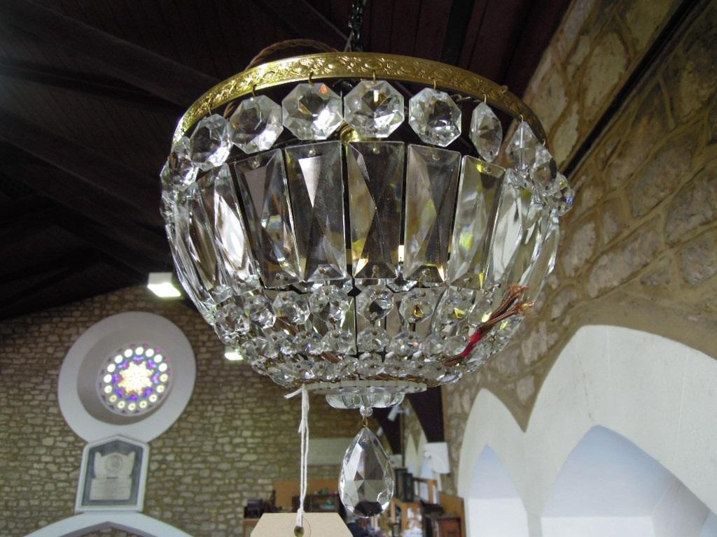 Appraisal: A bag chandelier with a single brass band hung with