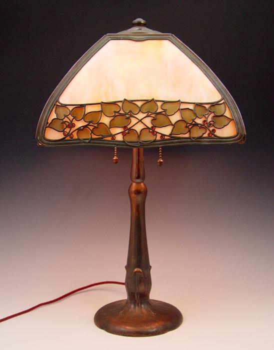 Appraisal: HANDEL TEROCA METAL OVERLAY LAMP Four curved slag glass panels