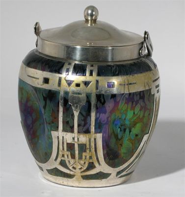 Appraisal: A Loetz metal mounted glass biscuit barrel and cover dimpled