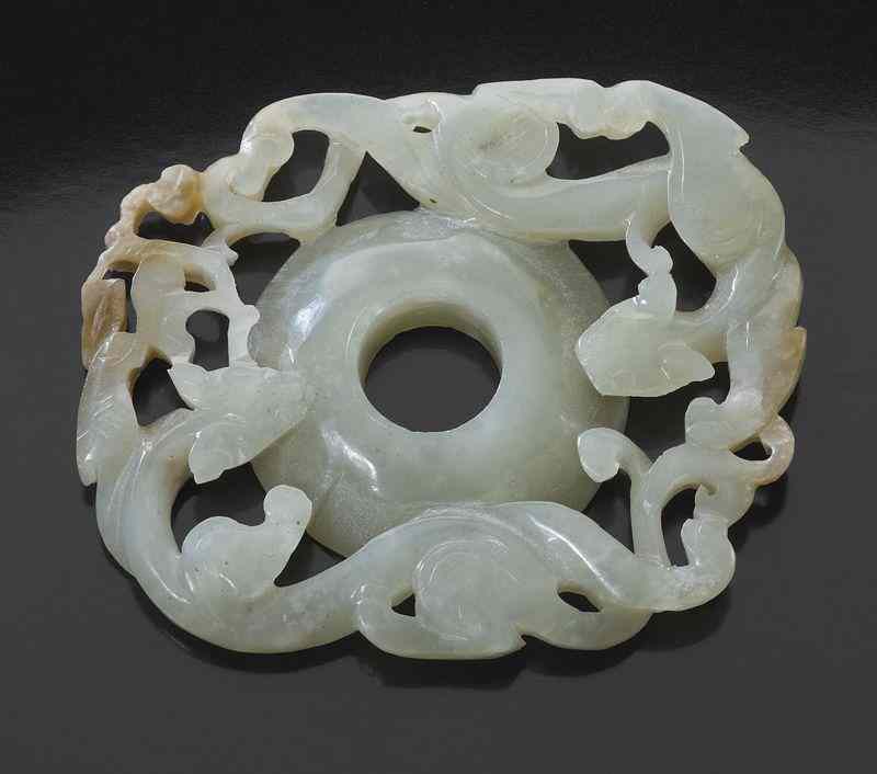 Appraisal: Chinese Ming carved jade bi-diskdepicting two chi-dragons ''H x ''W