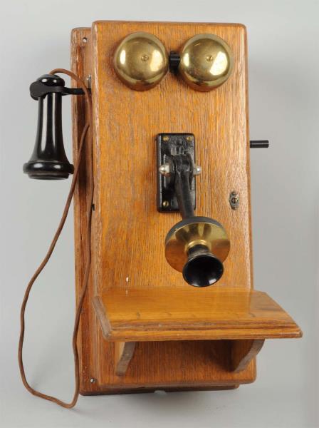 Appraisal: Hanging Wall Phone in Oak Case This early wall phone