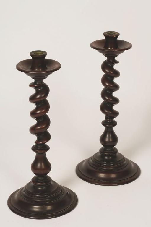 Appraisal: A PAIR OF VICTORIAN MAHOGANY CANDLESTICKS with broad drip pans