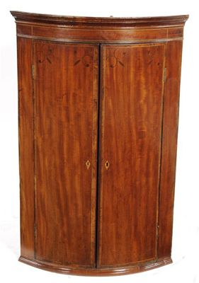 Appraisal: An early th century mahogany bowfront hanging corner cupboard with