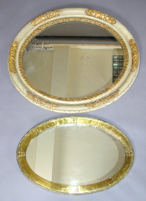 Appraisal: A gilt and cream painted oval wall mirror th century