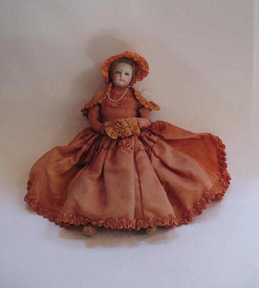 Appraisal: A VICTORIAN PORCELAIN HEADED DOLL with glass eyes and leather