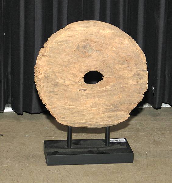 Appraisal: An Asian wooden wheel Raised on a black painted wood