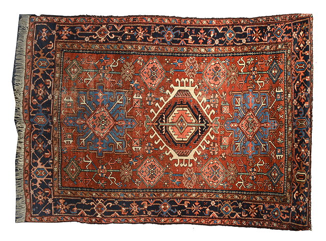 Appraisal: AN OLD HERIZ BRICK GROUND RUG with three stylised designs